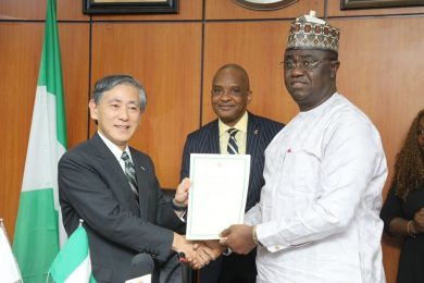 Honorable Minister of State Federal Ministry of Budget and National Planning, Prince Clem Agba (right) and Ambassador Extraordinary and plenipotentiary of Japan to Nigeria, His Excellency Kazuyoshi Matsunaga (left) holding the signed Exchange of Note (E/N) document while the Director General, Nigerian Maritime Administration and Safety Agency (NIMASA), Dr. Bashir Jamoh (middle) looks on during the signing of the Exchange of Note (E/N) with the Japanese Government for the Economic and Social Development Programme in Abuja.