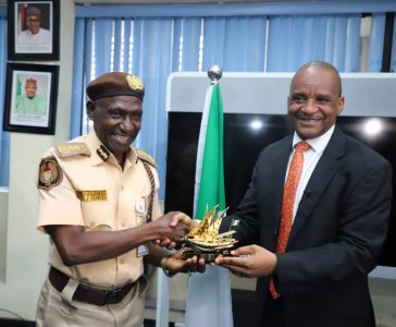 Director General, Nigerian Maritime Administration and Safety Agency (NIMASA), Dr. Bashir Jamoh (ri ght) presenting a souvenir to the Comptroller General of the Nigeria Immigration Service, Isah Idris Jere during the working visit by the Comptroller General to the NIMASA headquarters in Lagos.